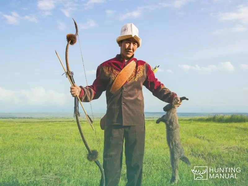 bow hunter with wild rabbit