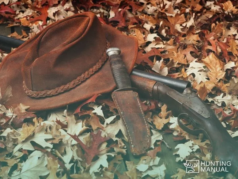 hunting rifle, knife and a hat